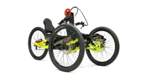 Sport-On Jeetrike: Handcycle 6 Adaptive four-wheeled off-road handcycle with large tyres and neon frame, enabling disabled access to outdoor activities and nature.